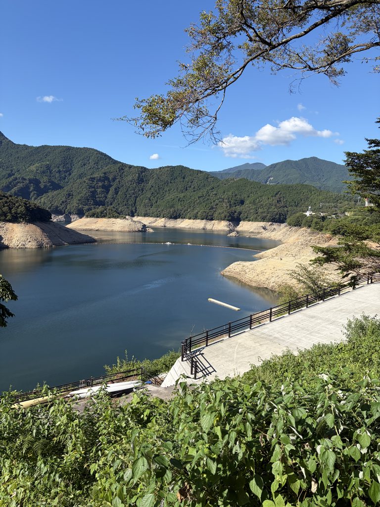 渇水で水位が下がった早明浦ダムの湖面と、露出した斜面